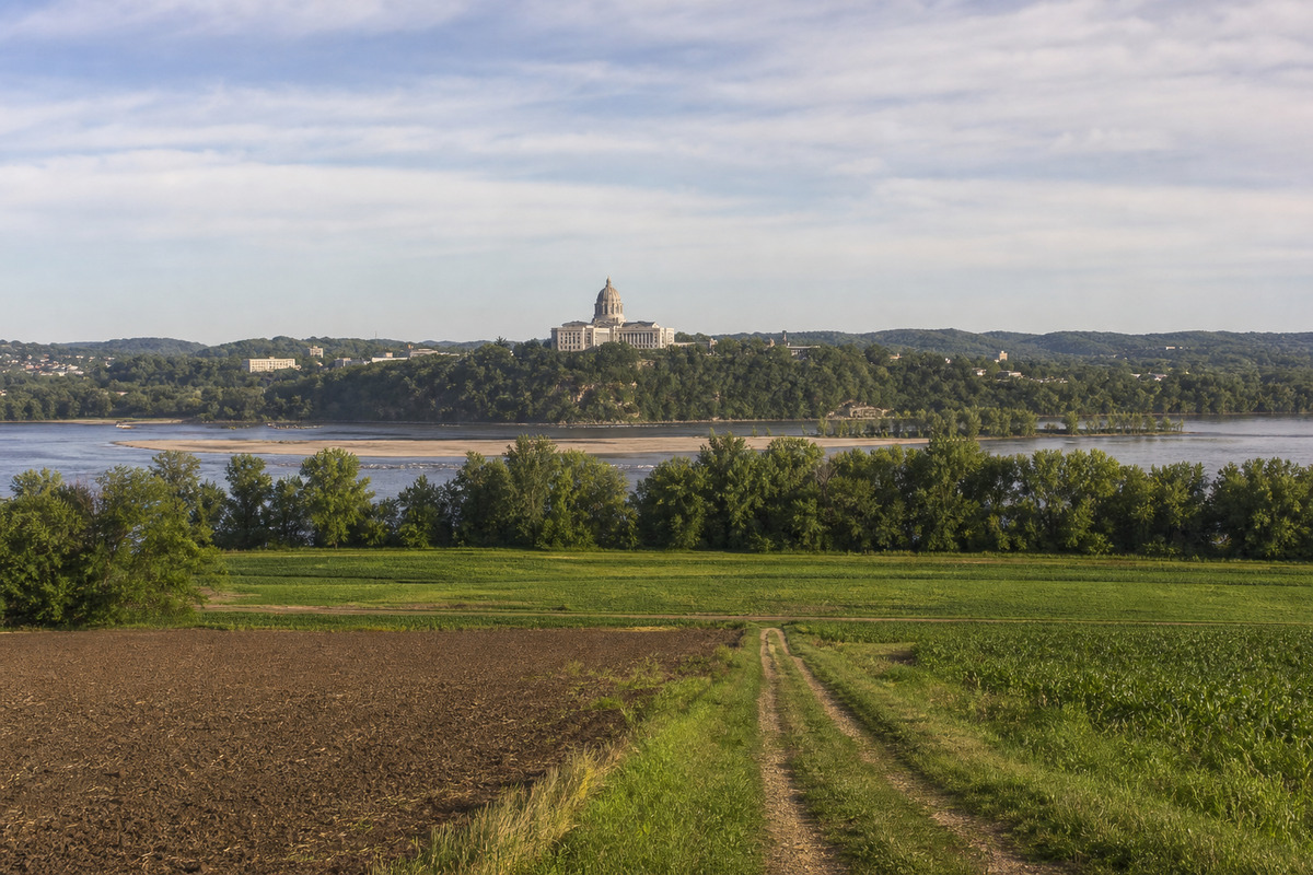 The Missouri State Capitol dome on its bluff above the Missouri River at Jefferson City with river bottom farm ground spreading below